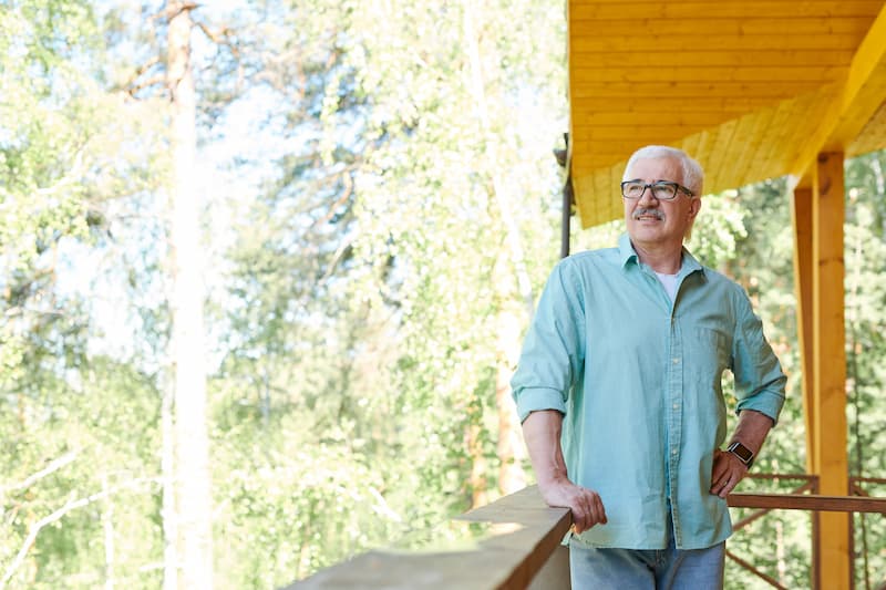 Man enjoying his retirement in his log cabin