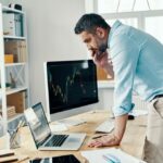 Man looking at retirement options deciding between a 401k or Roth IRA.