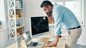 Man looking at retirement options deciding between a 401k or Roth IRA.