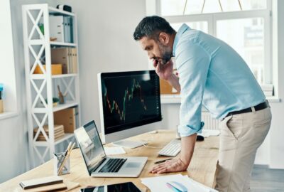 Man looking at retirement options deciding between a 401k or Roth IRA.