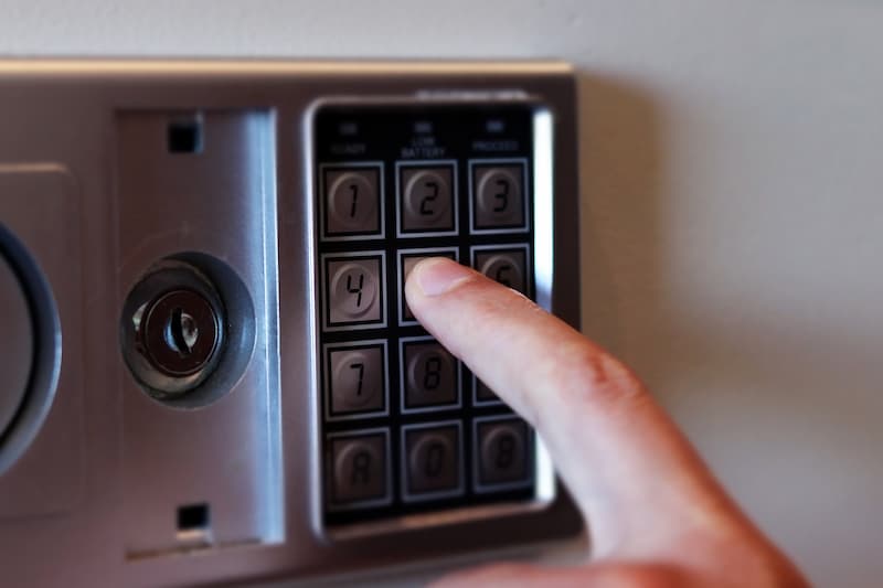 Man typing a safe keypad.