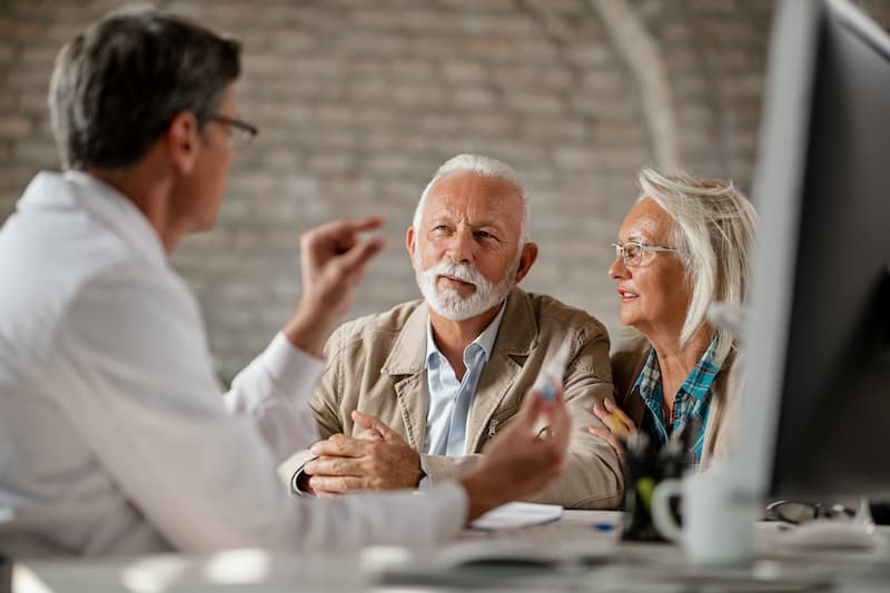 Financial adviser explaining catch up contributions to senior couple.